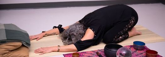 Candace Raynes practicing restorative yoga at Shifting Light Studio