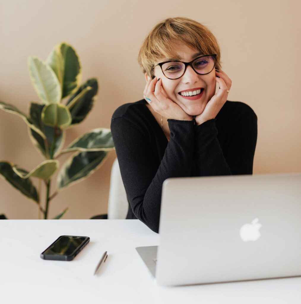 Smiling entrepreneur woman working at minimalist desk