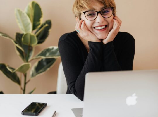 Smiling entrepreneur woman working at minimalist desk